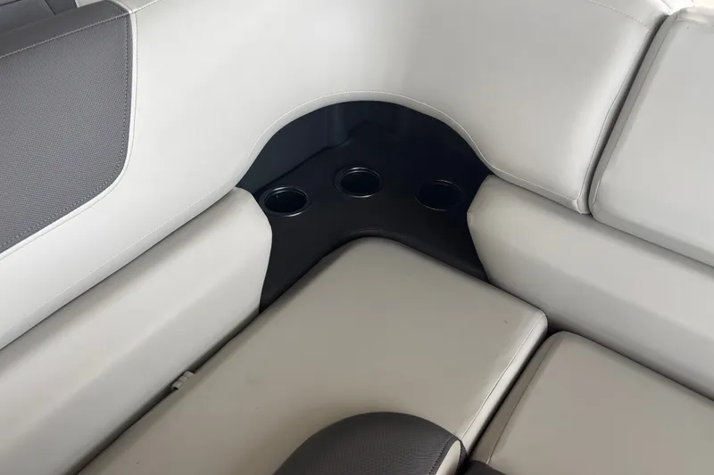 Slide: The Image of 2026 Sun Tracker Fishin' Barge 22 DLX interior seating with cup holders. - 15