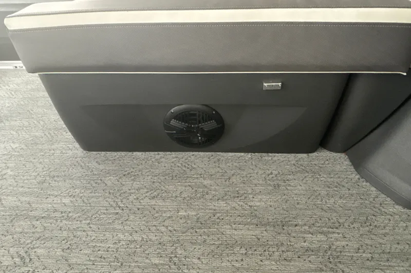 Slide: The Image of 2026 Sun Tracker Fishin' Barge 22 DLX interior seating with integrated speaker. - 17