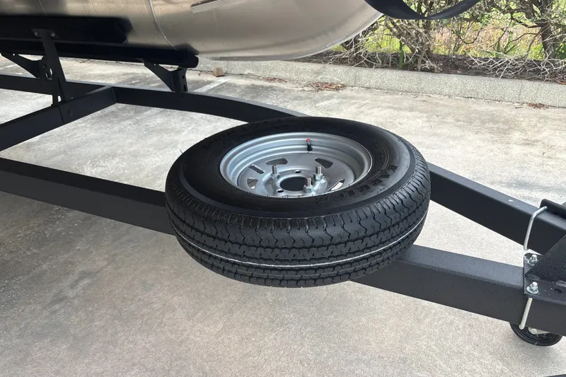 Slide: The Image of Spare tire mounted on a 2026 Sun Tracker Fishin' Barge 22 DLX trailer. - 44