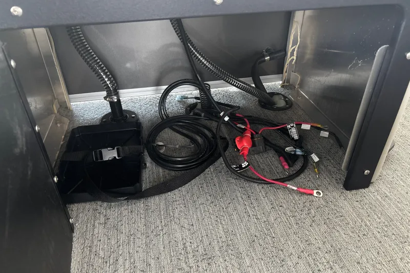 Slide: The Image of Under-seat wiring and battery compartment of 2026 Sun Tracker Fishin' Barge 22 DLX. - 42
