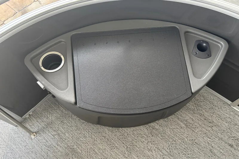 Slide: The Image of 2026 Sun Tracker Fishin' Barge 22 DLX console with cup holder and storage compartment. - 22