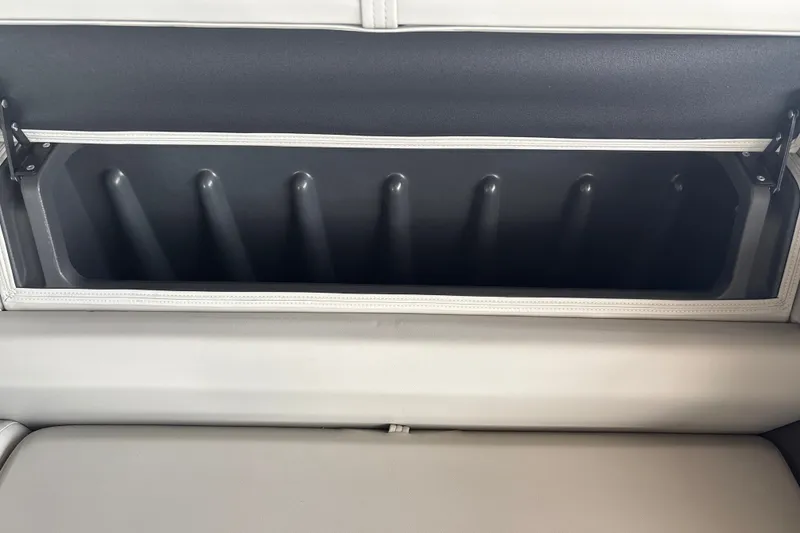 Slide: The Image of 2026 Sun Tracker Fishin' Barge 22 DLX rod storage compartment, open and empty. - 32