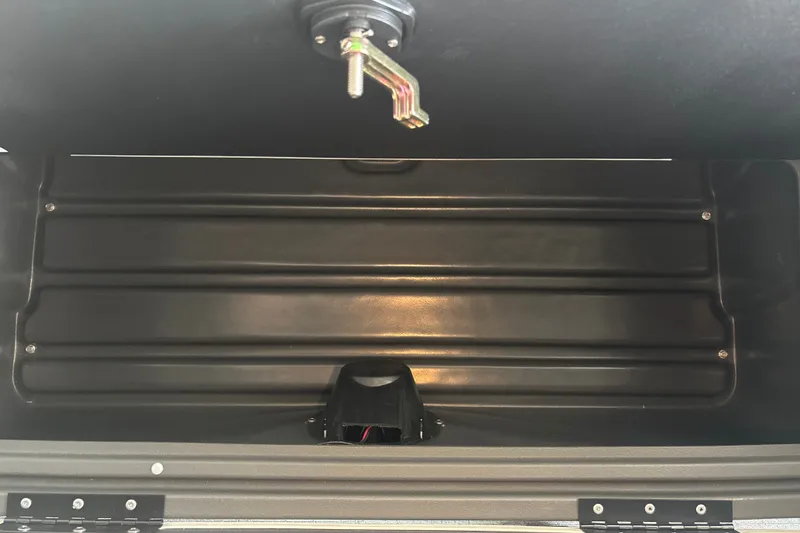 Slide: The Image of Storage compartment of 2026 Sun Tracker Fishin' Barge 22 DLX, featuring durable black interior. - 34