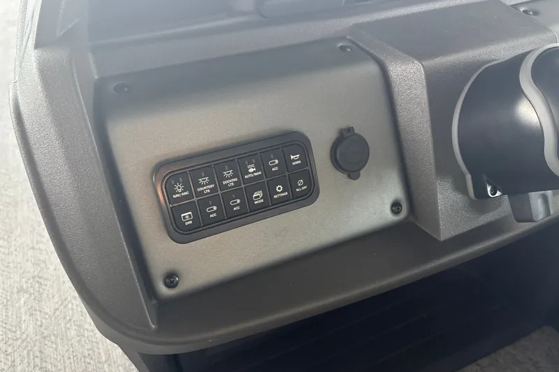 Slide: The Image of Control panel of 2026 Sun Tracker Fishin' Barge 22 DLX boat dashboard. - 21