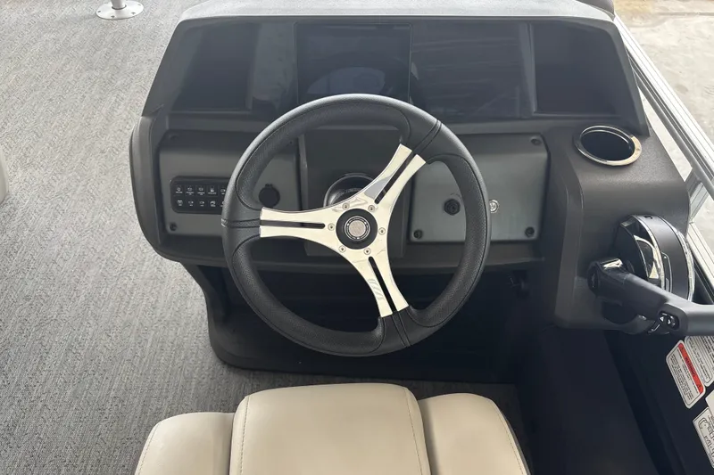 Slide: The Image of Steering console of 2026 Sun Tracker Fishin' Barge 22 DLX with modern controls. - 20