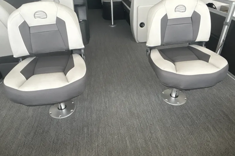 Slide: The Image of 2026 Sun Tracker Fishin' Barge 22 DLX interior with two cushioned swivel seats. - 14