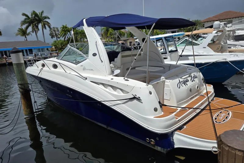 The Image of 2006 Sea Ray Sundancer 320 yacht docked, featuring sleek design and blue hull. - 0