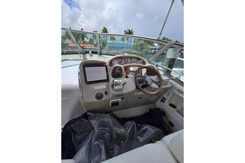 Slide: The Image of Cockpit of 2006 Sea Ray Sundancer 320 with steering wheel and control panel. - 12
