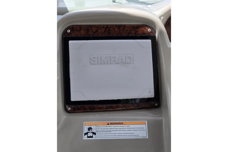 Slide: The Image of Simrad navigation system on 2006 Sea Ray Sundancer 320 dashboard with warning label. - 13