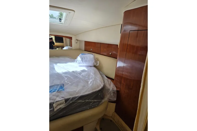 Slide: The Image of Interior cabin of 2006 Sea Ray Sundancer 320 with bed and wooden cabinetry. - 17