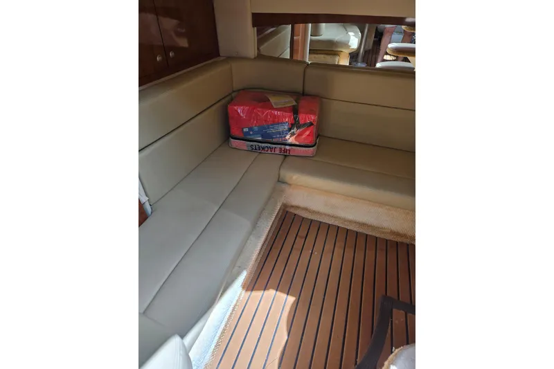 Slide: The Image of Interior of 2006 Sea Ray Sundancer 320 with beige seating and life jackets. - 27