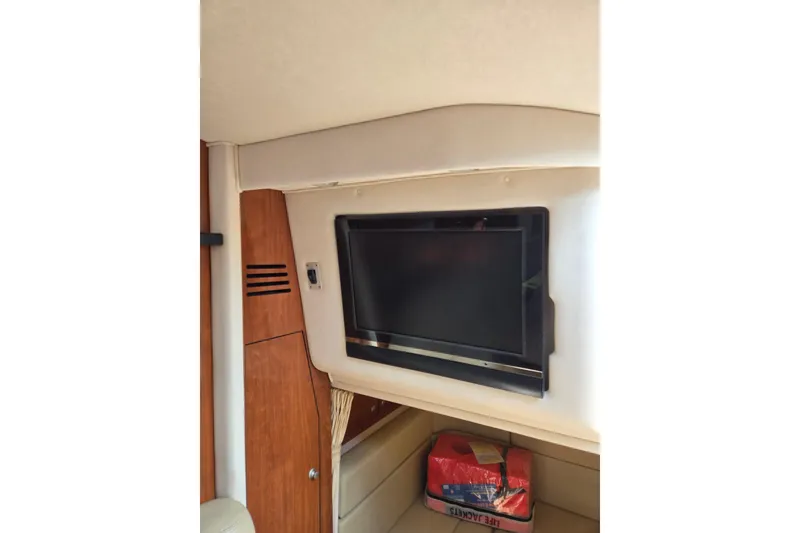 Slide: The Image of Interior of 2006 Sea Ray Sundancer 320 with mounted TV and storage area. - 28