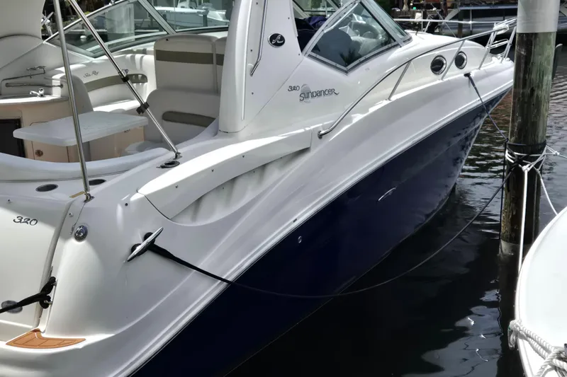 Slide: The Image of 2006 Sea Ray Sundancer 320 yacht docked, showcasing sleek design and luxurious interior. - 3