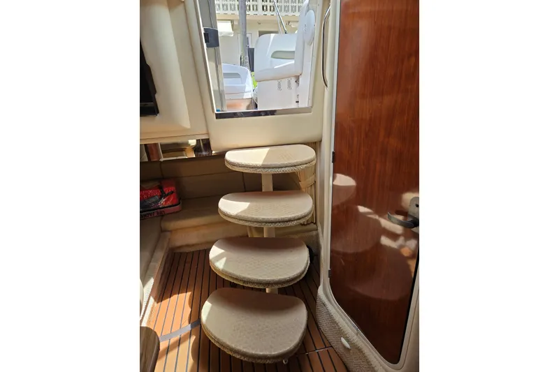 Slide: The Image of Interior stairs of 2006 Sea Ray Sundancer 320 yacht, featuring wooden flooring and elegant design. - 30