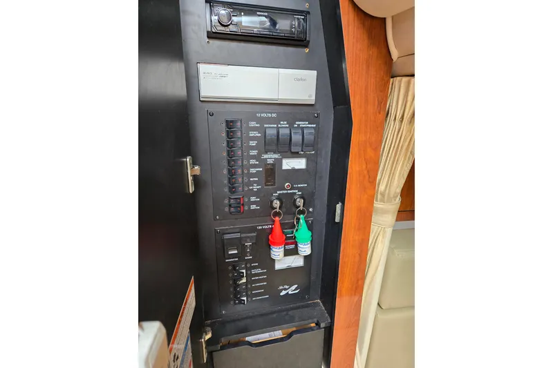 Slide: The Image of Control panel of a 2006 Sea Ray Sundancer 320 boat, featuring switches and keys. - 31
