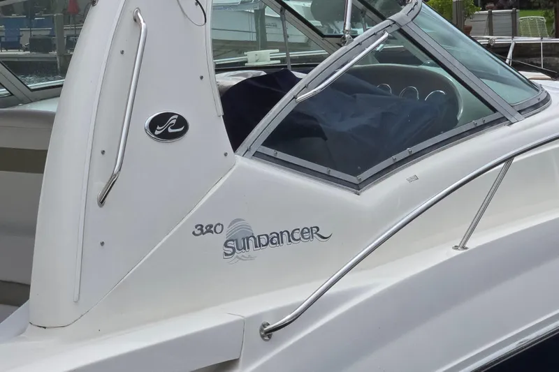 Slide: The Image of 2006 Sea Ray Sundancer 320 boat side view with logo and windshield. - 33