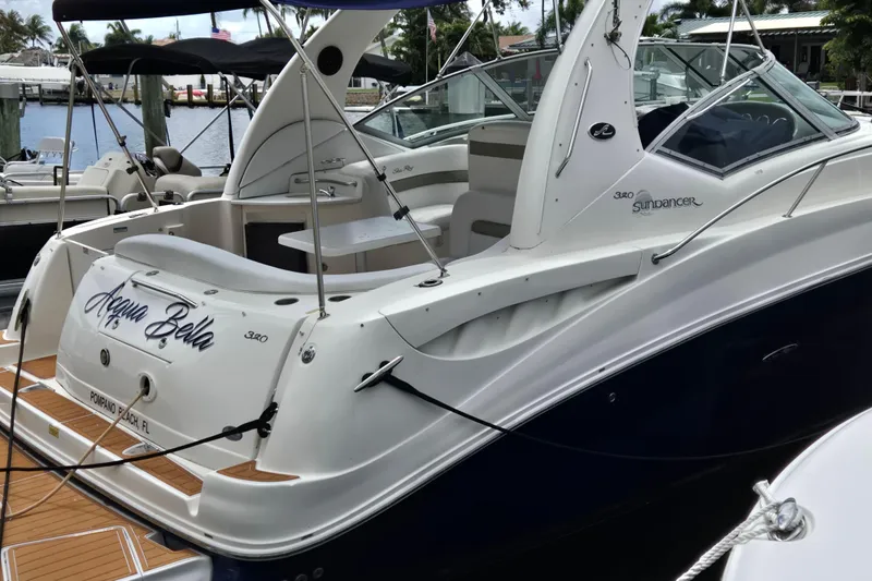 Slide: The Image of 2006 Sea Ray Sundancer 320 docked, featuring sleek design and spacious deck area. - 34