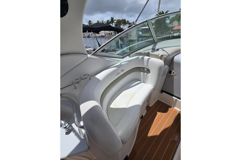 Slide: The Image of 2006 Sea Ray Sundancer 320 interior with white seating and wooden flooring. - 9