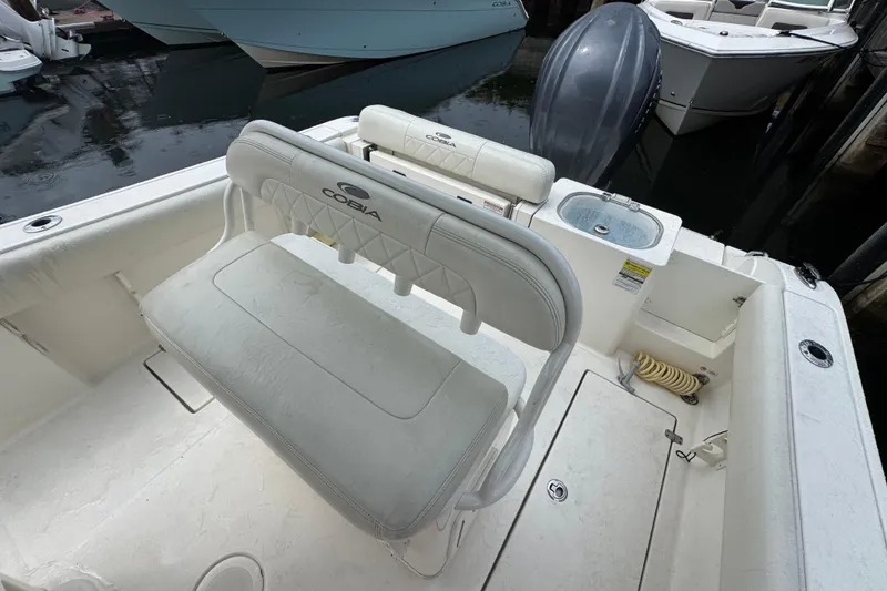 Slide: The Image of 2021 Cobia 237 Center Console boat interior with seating and storage features. - 12