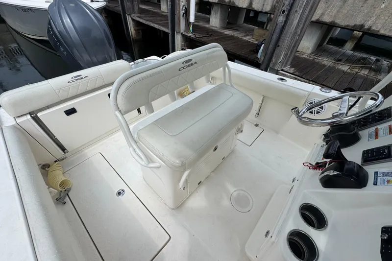 Slide: The Image of 2021 Cobia 237 Center Console boat interior with seating and steering wheel. - 13