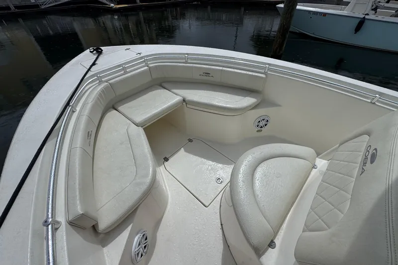 Slide: The Image of 2021 Cobia 237 Center Console boat with cushioned seating and sleek design. - 9