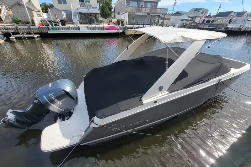 Slide: The Image of 2018 Regal 26 OBX boat docked, featuring Yamaha outboard motor and covered seating area. - 13