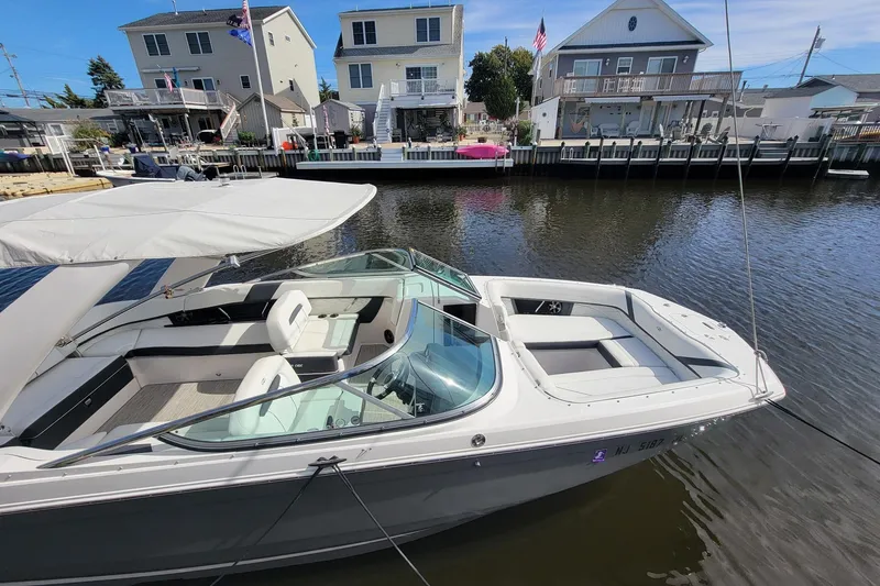 Slide: The Image of 2018 Regal 26 OBX boat docked in a residential canal setting. - 3