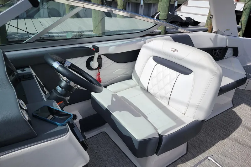 Slide: The Image of 2018 Regal 26 OBX boat interior with steering wheel and white seating. - 6