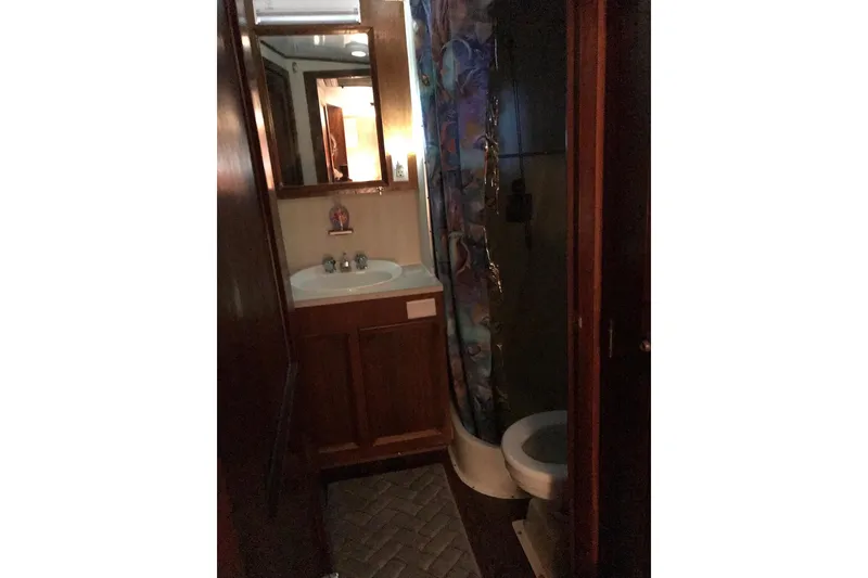Slide: The Image of Bathroom interior of a 1976 Hatteras 53 Convertible yacht with sink and shower. - 10