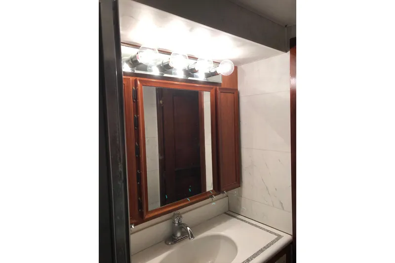 Slide: The Image of Bathroom vanity with mirror and lights on 1976 Hatteras 53 Convertible yacht. - 15