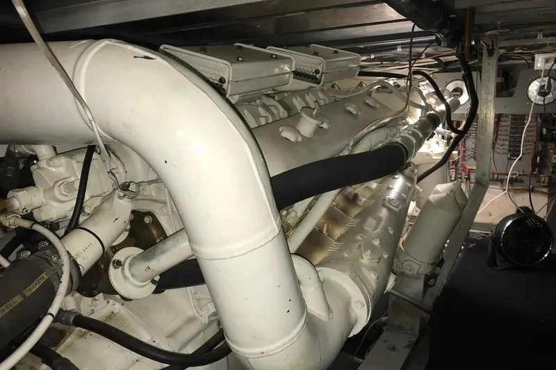 Slide: The Image of Engine room of a 1976 Hatteras 53 Convertible yacht, showcasing complex machinery. - 18