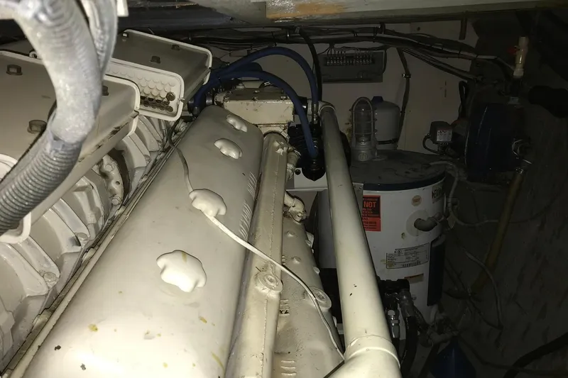 Slide: The Image of Engine room of a 1976 Hatteras 53 Convertible yacht, showcasing machinery and components. - 19