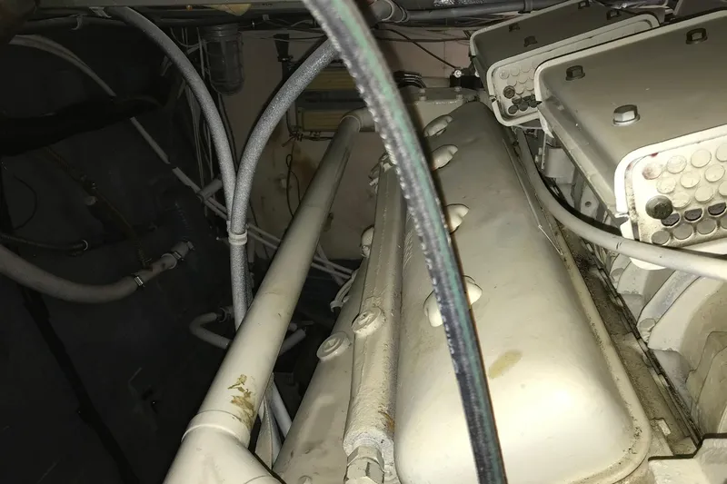 Slide: The Image of Engine room of a 1976 Hatteras 53 Convertible yacht, showcasing mechanical components. - 21