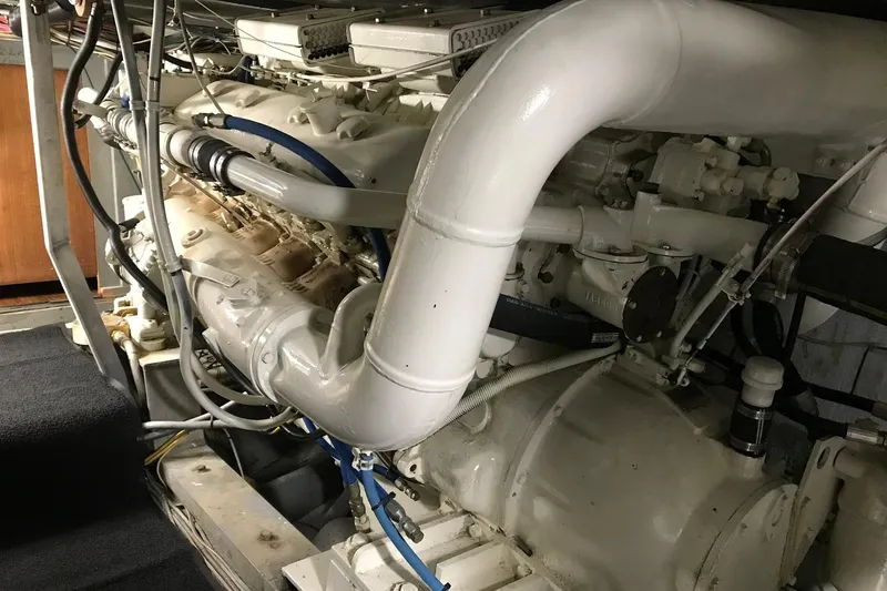 Slide: The Image of Engine room of a 1976 Hatteras 53 Convertible yacht, showcasing mechanical components and controls. - 35