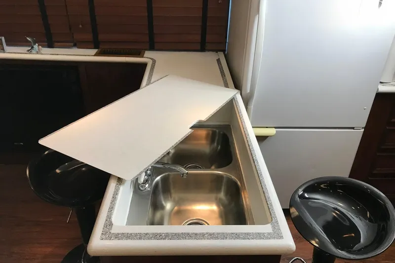 Slide: The Image of Interior of 1976 Hatteras 53 Convertible yacht kitchen with sink and bar stools. - 4