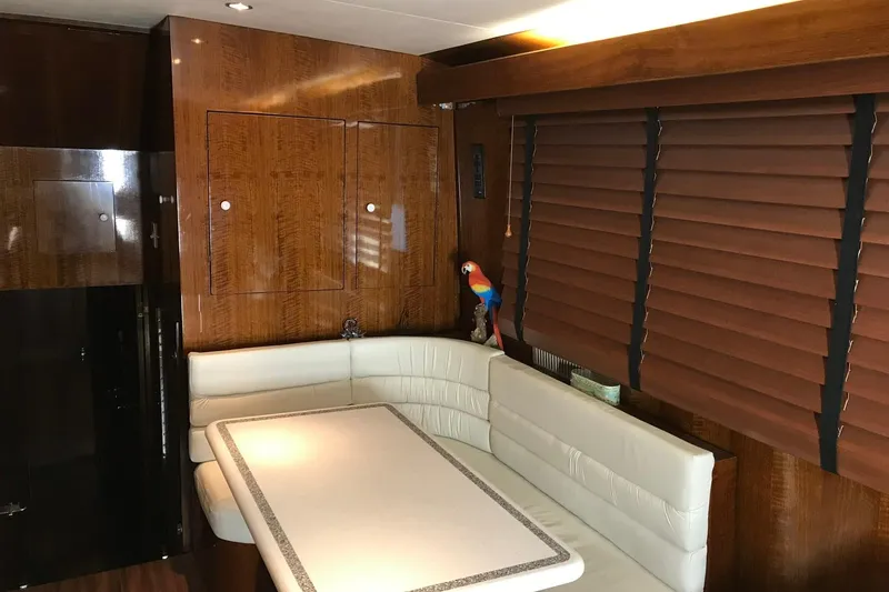 Slide: The Image of Interior of 1976 Hatteras 53 Convertible yacht with wood paneling and white seating. - 7