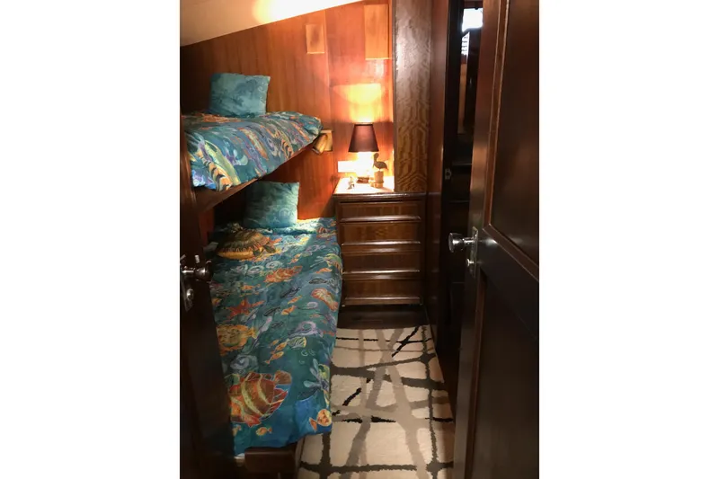 Slide: The Image of Interior of 1976 Hatteras 53 Convertible yacht with cozy bunk beds and wooden cabinetry. - 8