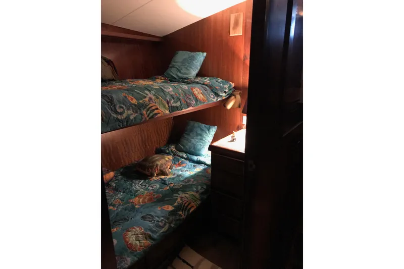 Slide: The Image of Interior of 1976 Hatteras 53 Convertible with cozy bunk beds and nautical decor. - 9