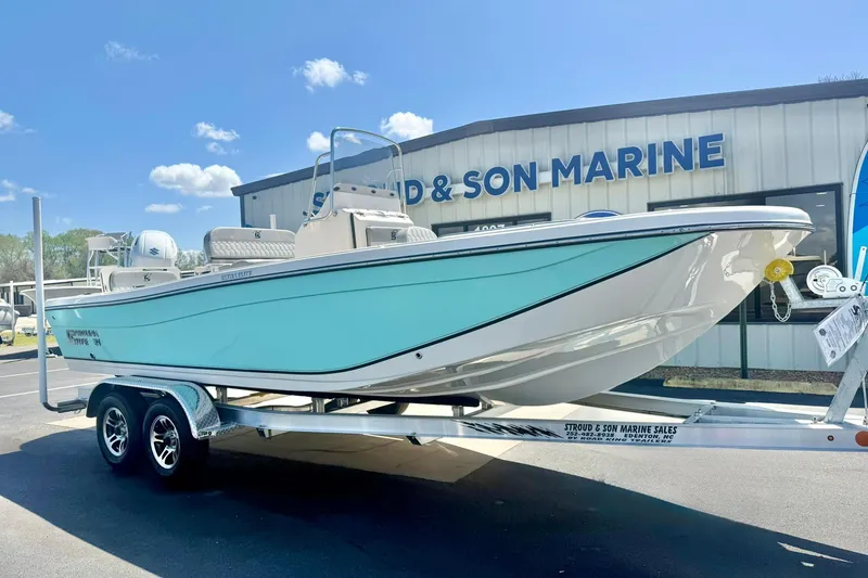 The Image of 2026 Carolina Skiff 21 Ultra Elite boat on trailer at marine dealership. - 1