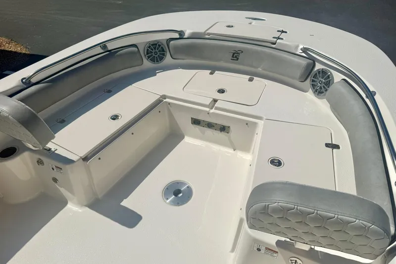 Slide: The Image of 2026 Carolina Skiff 21 Ultra Elite boat interior with cushioned seating and storage compartments. - 12