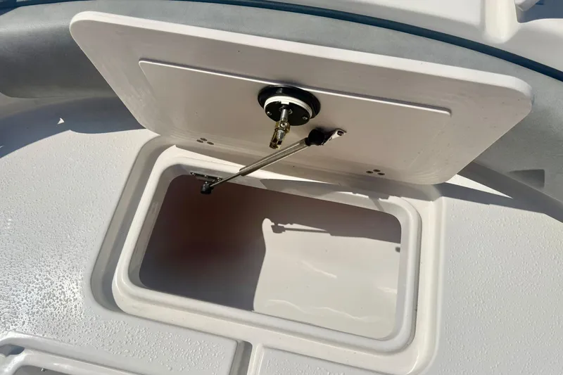 Slide: The Image of 2026 Carolina Skiff 21 Ultra Elite storage compartment with open hatch, showcasing interior space. - 14