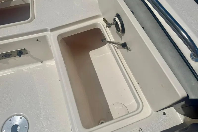 Slide: The Image of 2026 Carolina Skiff 21 Ultra Elite boat storage compartment detail. - 15