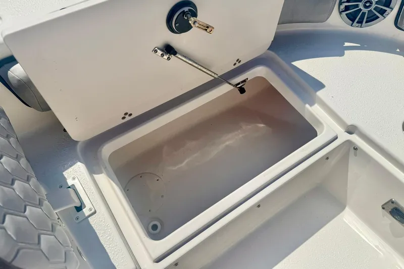 Slide: The Image of 2026 Carolina Skiff 21 Ultra Elite boat storage compartment with open lid. - 17