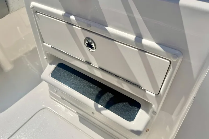 Slide: The Image of 2026 Carolina Skiff 21 Ultra Elite storage compartment with secure latch and sleek design. - 24