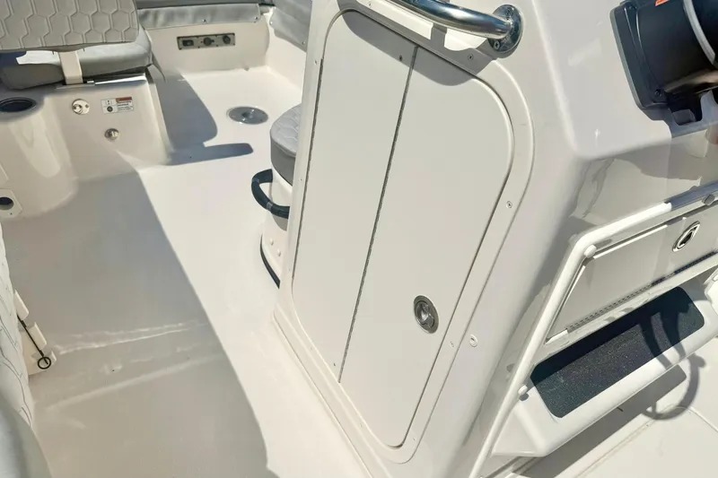 Slide: The Image of 2026 Carolina Skiff 21 Ultra Elite boat interior with seating and storage compartments. - 26