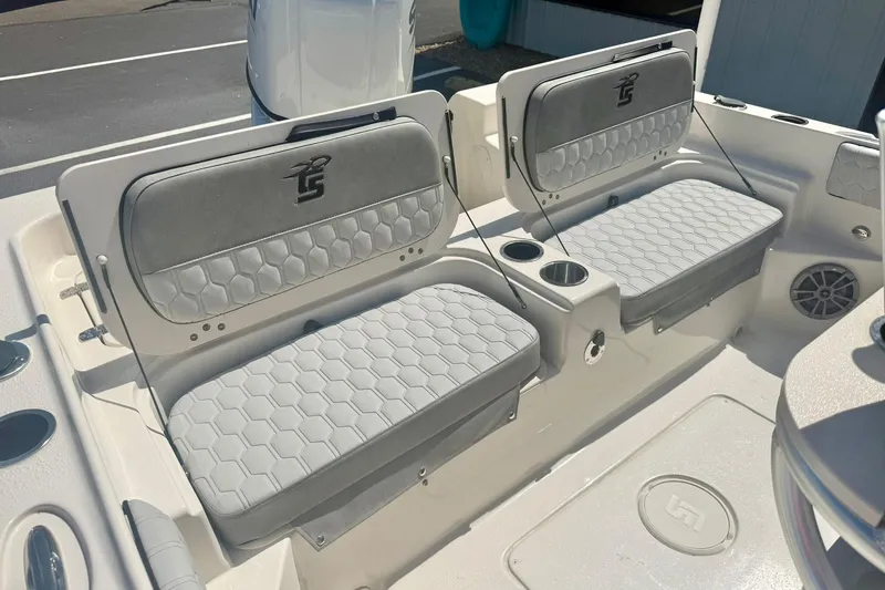 Slide: The Image of 2026 Carolina Skiff 21 Ultra Elite boat seating with gray cushions and cup holders. - 29