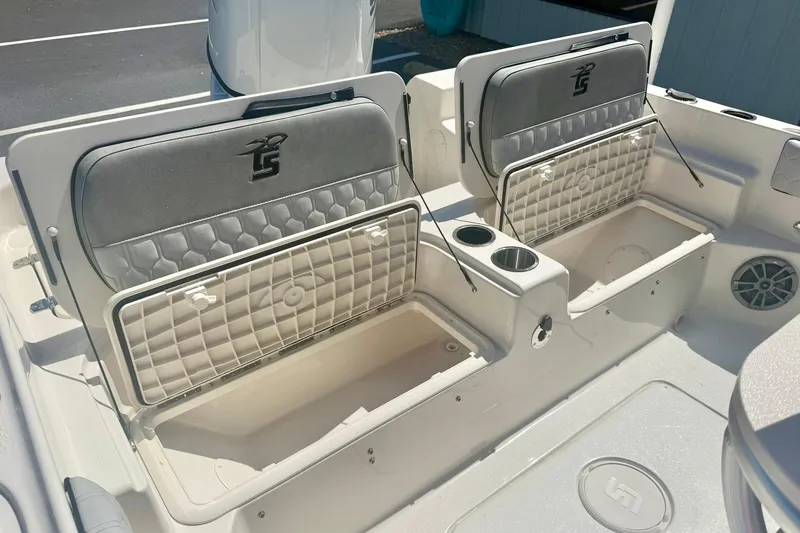 Slide: The Image of 2026 Carolina Skiff 21 Ultra Elite boat seating with storage compartments and cup holders. - 30
