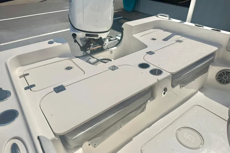 Slide: The Image of 2026 Carolina Skiff 21 Ultra Elite boat interior with storage compartments and motor. - 32
