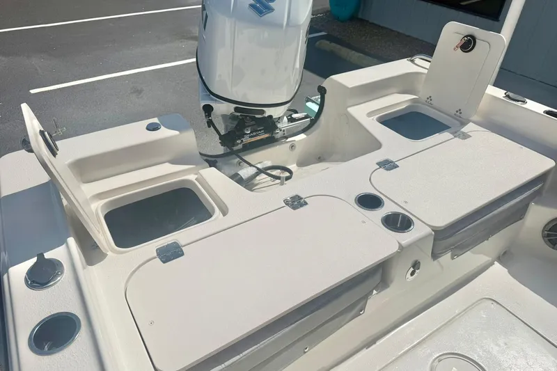 Slide: The Image of 2026 Carolina Skiff 21 Ultra Elite boat interior with storage compartments and motor. - 33