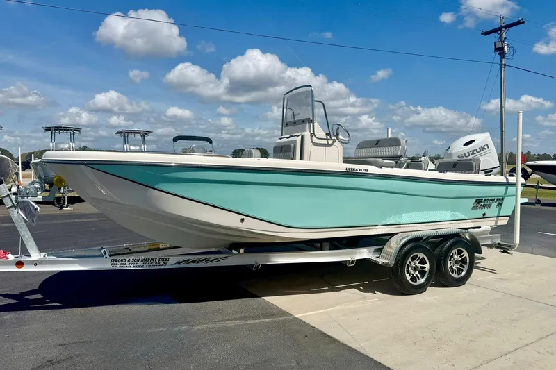 Slide: The Image of 2026 Carolina Skiff 21 Ultra Elite boat on trailer under blue sky. - 5